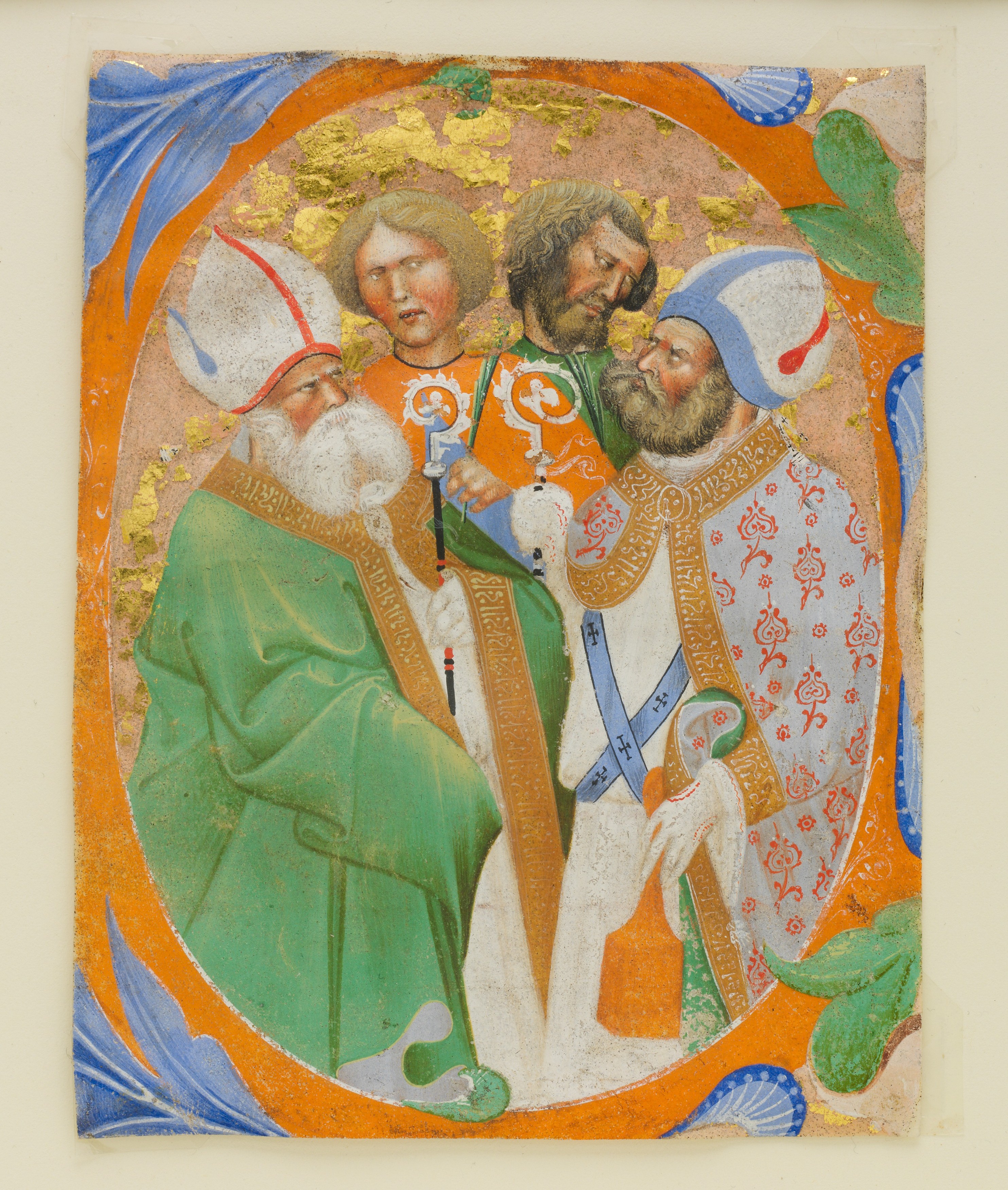 Medieval illumination with four saints inside an initial letter